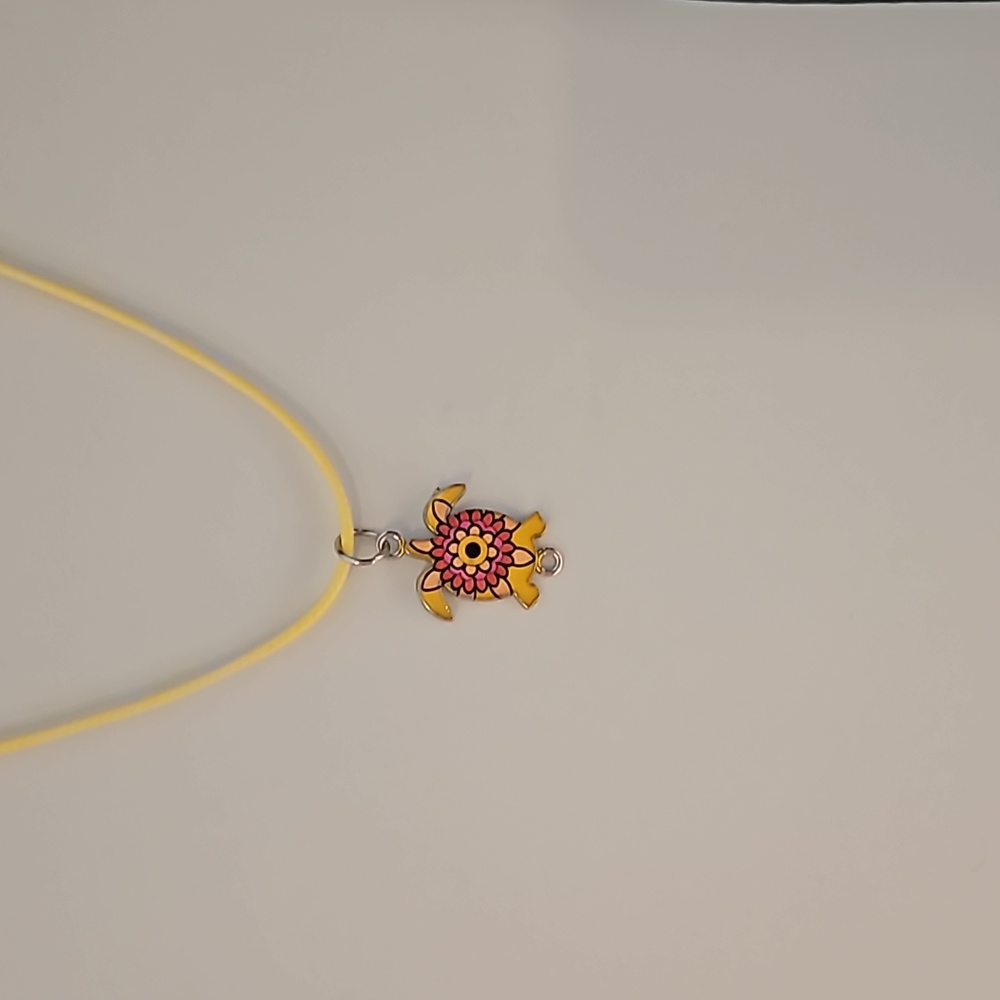 Turtle charm on leather corded necklace
